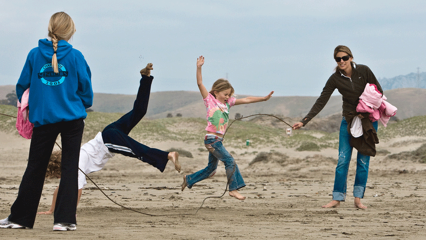 Kids play skiprope on Morro Strand State Beach