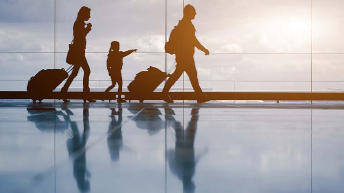 Family with luggage walking at airport