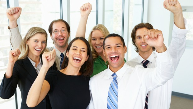 Happy workers cheering in an office