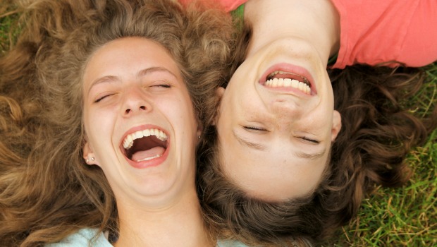 Women on grass laughing
