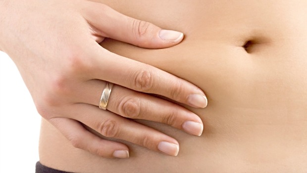 Woman squeezing her stomach