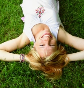 A woman laying out in the grass.