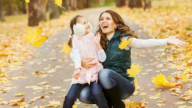 Mom and child in falling leaves