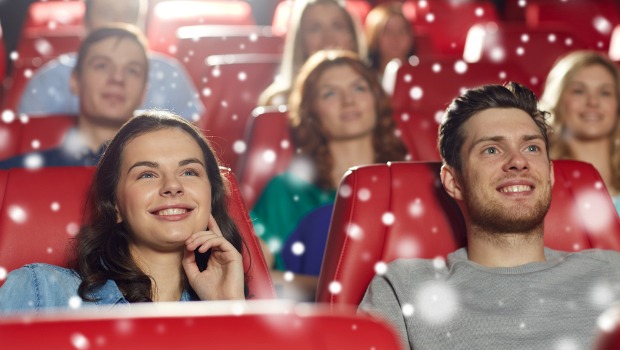Young couple watching a movie in theater.