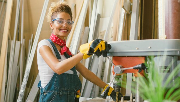 Confident woman working with a table saw.