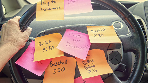 Many post-its on a steering wheel.