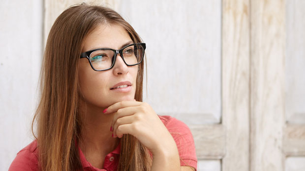 Woman in glasses looking pensive.
