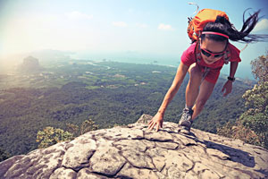 Woman climbing a mountain