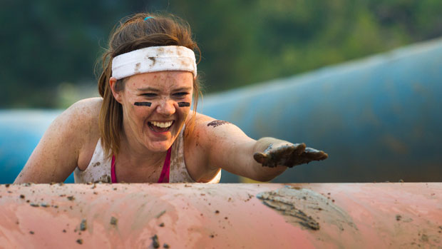 Woman participating in a mud run.