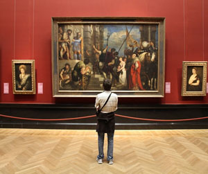 Man looking at a painting