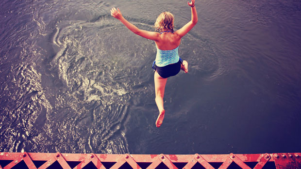 Woman jumping off a bridge