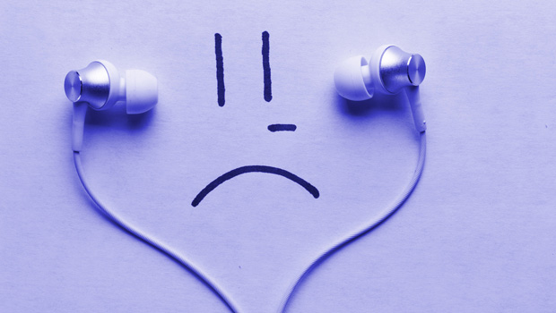 Purple sad face listening to earbuds.