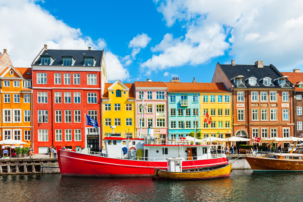 Famous Nyhavn pier with colorful buildings and boats in Copenhagen, Denmark