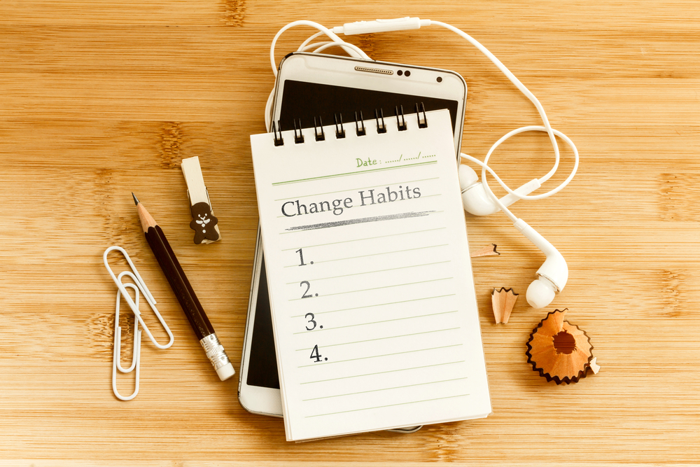 Hand written Change habits message notepad with pencil on wooden table for change habits list for good life concept , overhead shot