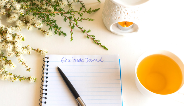 Gratitude journal and cup of tea