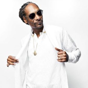 Snoop Dog wearing gold chain and white clothing